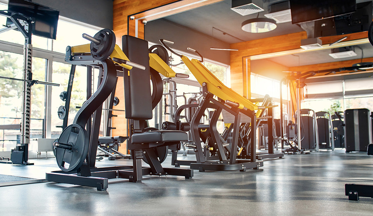 Gym facility with equipment and machines.