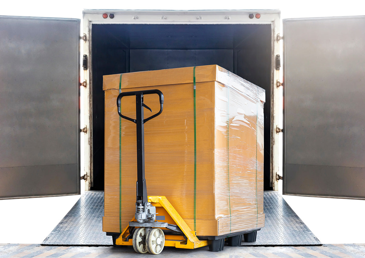 Hand pallet jack with a large goods pallet loading into container truck.